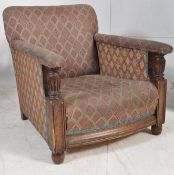 A 1920's low chesterfield style bergere armchair. Turnwood show front arms with deep frame