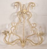 A cast metal 20th century shabby chic chandelier with arms that swivel allowing the item to place