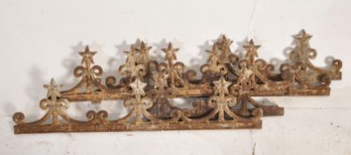 A set of 4 Victorian cast iron painting railing top rails having fleur de lys with star mounts on
