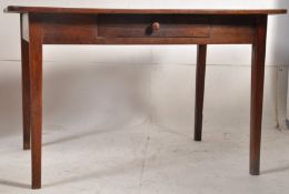 A 19th century French provincial oak kitchen dining table. Raised on square tapered legs having a