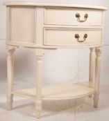 A Laura Ashley painted demi-lune hallway / console table cabinet. Raised on turned legs united by
