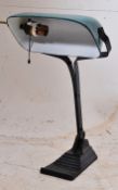 A vintage 1930's wrought iron and glass shade Industrial bankers lamp. THe ebonised iron support