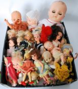 A collection of vintage dolls to include plastic, miniature, babies, clothed dolls and others. See