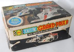 A vintage Scalextric Grand Prix 8 electric toy racing car game being complete with the original