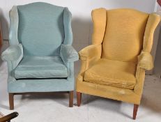 A near pair of mid 20th century wingback armchairs. One raised on square supports, the other