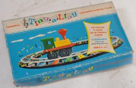 A 1950's Ting A Ling boxed clockwork tin plate musical train on track in the original box ( see