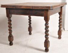 A 1930's large oak barleytwist draw leaf refectory dining table. The thick barley twist legs