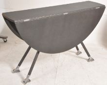 A Mafis contemporary die cast Aluminium drop leaf dining table raised on atomic style base with