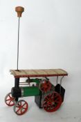 A vintage Mamod steam traction engine, being pistol driven with original turning rod and fire box.