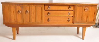 A 1960's retro teak Danish low sideboard dresser. Raised on tapered legs having end cupboard with