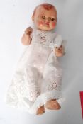 An early 20th century childs doll of composite construction having rolling eyes and a laceworked