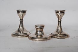 Two silver candlesticks Birmingham date letter v for 1920 stands 8.5 cms high and an inkwell