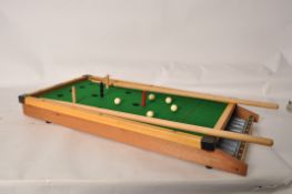 A boxed bar billiards game complete with cue, balls accessories etc in the original box