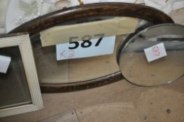 A collection of 3 vintage mirrors including one oval, round and square.