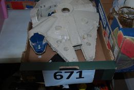 An original Millenium Falcon Star Wars toy.
