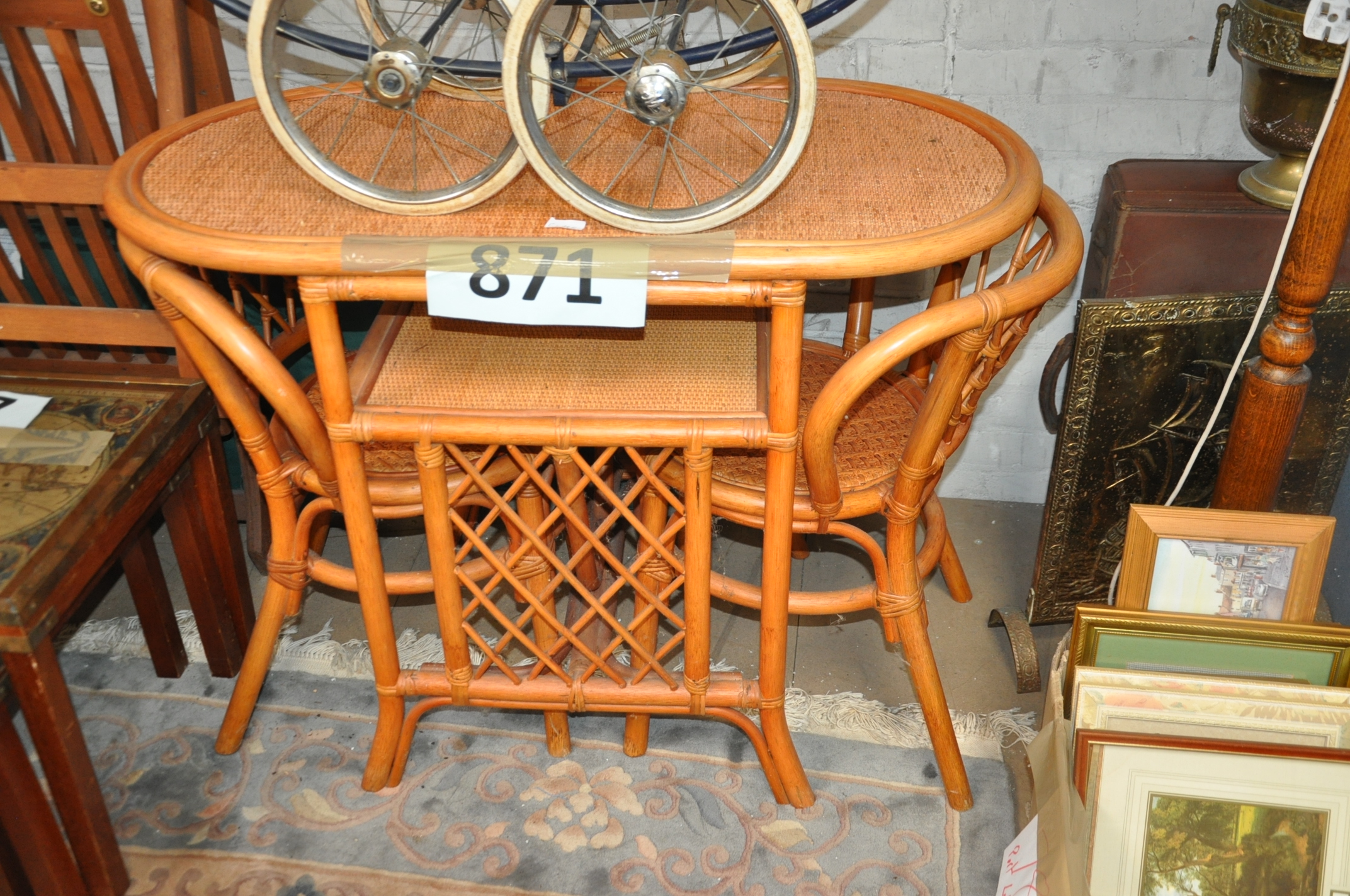 A 20th century wicker conservatory set consisting of a dining table and 2 chairs.