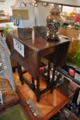 A 1940's gate leg drop leaf table on square supports and turned legs.