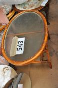 A glass topped conservatory wicker constructed table, oval shaped.