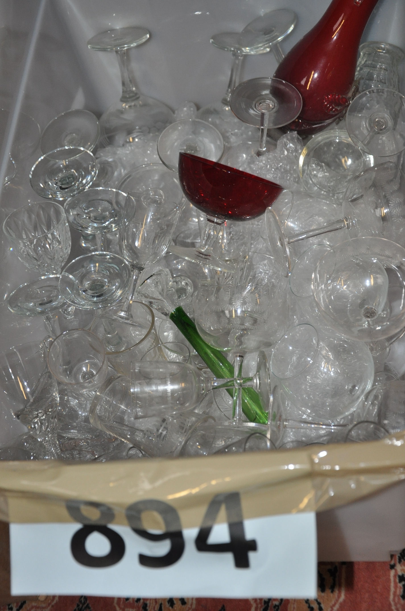 A box of glassware to include wine glasses, tumblers and other items.