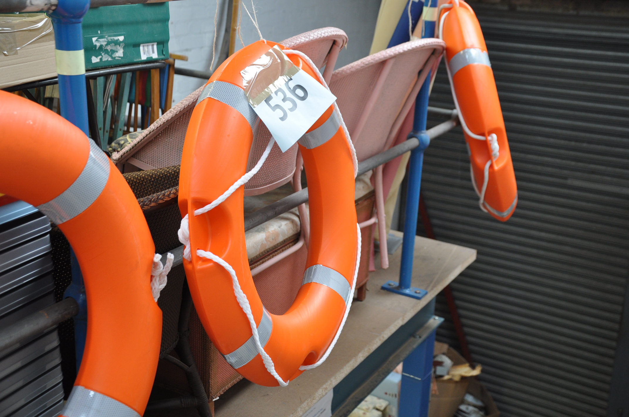 3 new unused boating life preserver buoys in orange with fluorescent ribbon trims.