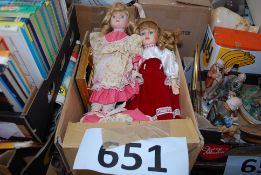 Two vintage porcelain dolls along with some picture frames and other items.