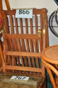 A teak wood steamer deck chair with cushion.