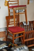 A pair of 1930's dining chairs with red upholstery.