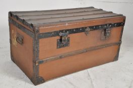 A canvas, wooden and metal bound steamer trunk / blanket box bearing original retailers labels to