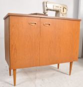 A retro 1960's Electric Singer sewing machine cabinet. The flip top cabinet with affixed Singer