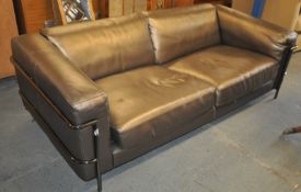 A large contemporary faux leather and chrome sofa settee. The chrome legs with chrome exterior frame