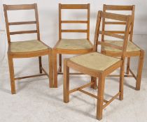 A set of 4 1930's Art Deco oak dining chairs. Drop in seats with railed back rests on square