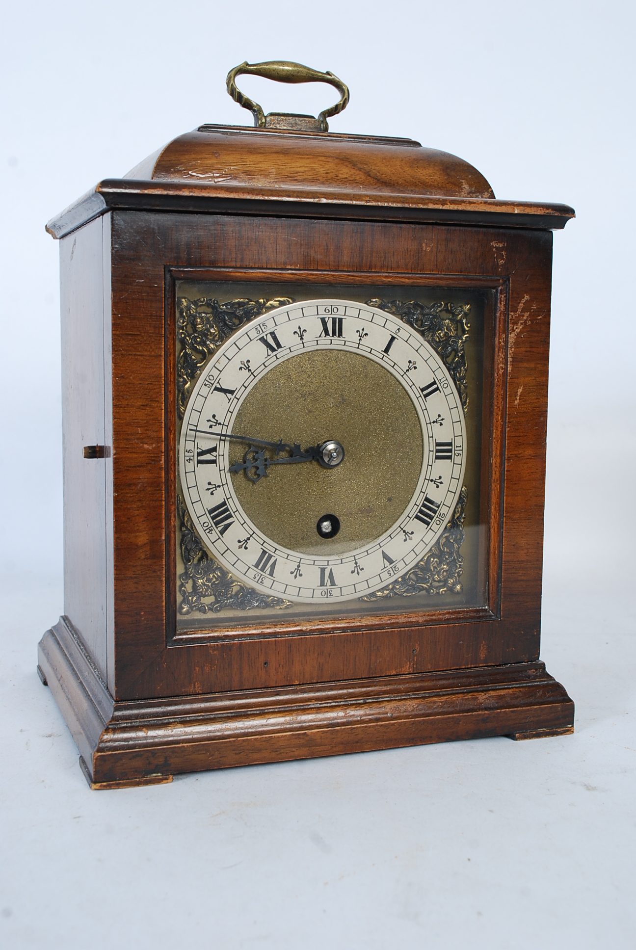 A mahogany cased bracket clock in the 18th century style having enamel dial with gilt metal