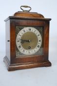 A mahogany cased bracket clock in the 18th century style having enamel dial with gilt metal