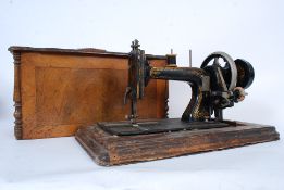 A vintage Singer sewing machine dating to the 19th century sat within a mahogany case. The machine