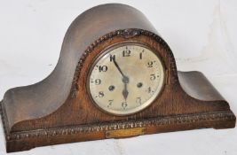 A 1926 oak cased 8 day movement mantel clock having napoleon hat case with brass notation plaque