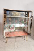 A very good retro 1950's mirror back and formica display cabinet. Raised on  tapered legs with