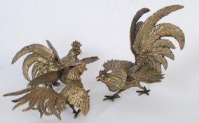 Three decorative table top gilt metal figurines of fighting cocks