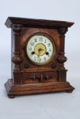 A Hamburg America Company HAC mantle clock set within a mahogany case having columns to sides. The 8
