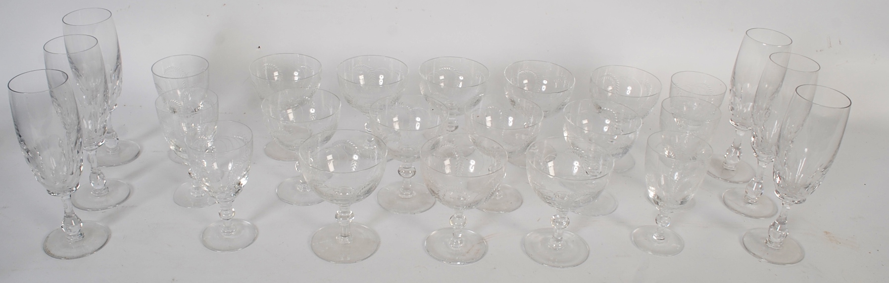 A collection of Barley patterened crystal glasses. Fluted glasses on raised stems, along with 6