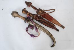 2 Indian Kukrie Knives / Daggers in leather scabbards together with a further Indian dagger in