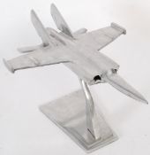 A large 20th century aluminium model of a Jet fighter raised on a plinth base