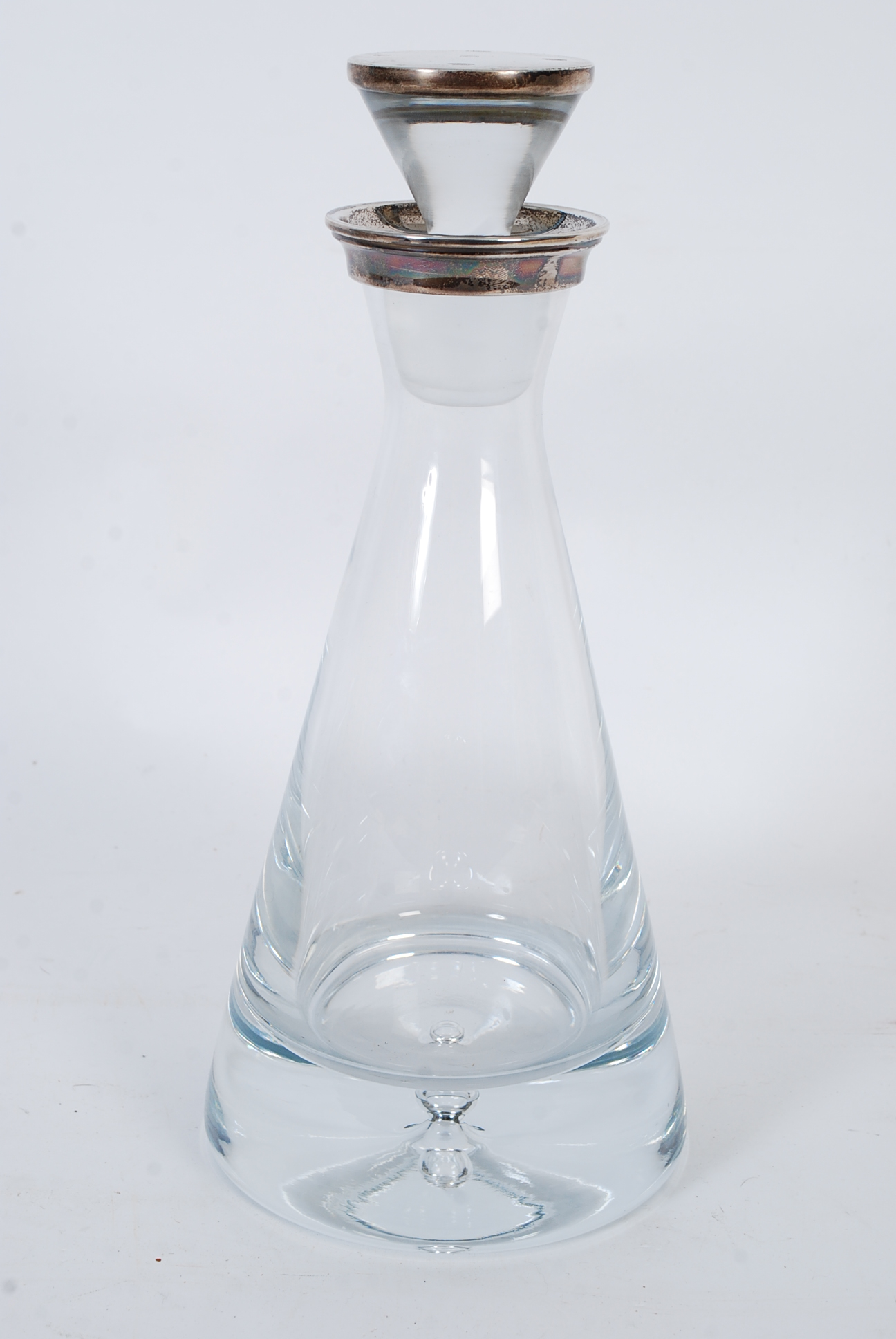 A contemporary conical decanter, silver mounted conical stopper, flared collar, heavy base with