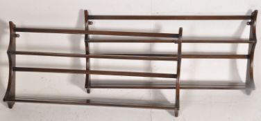 A pair of 1970's Ercol beech and elm hanging  plate racks. Shaped sides with central shelves and