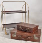 A metamorphic butlers trolley together with a pair of vintage leather suitcases. The trolley 80cms