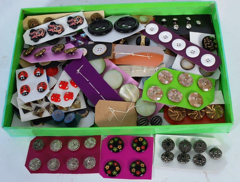 A collection of vintage buttons to include coloured glass, Minnie Mouse, elephants etc.
