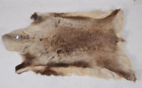 A retro large thick deer skin rug dating to the 1970's. Measures 152cms long x 90cms wide