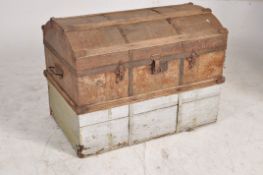 A 19th century metal and wooden bound dome top steamer trunk having carry handles to the sides