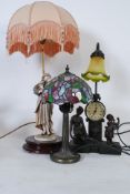 An Armani figurine lamp together with a Tiffany lamp and another with glass shade in faux spelter.
