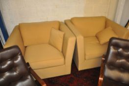 A good oversized pair of armchairs in the Edwardian style upholstered in a sand coloued quality