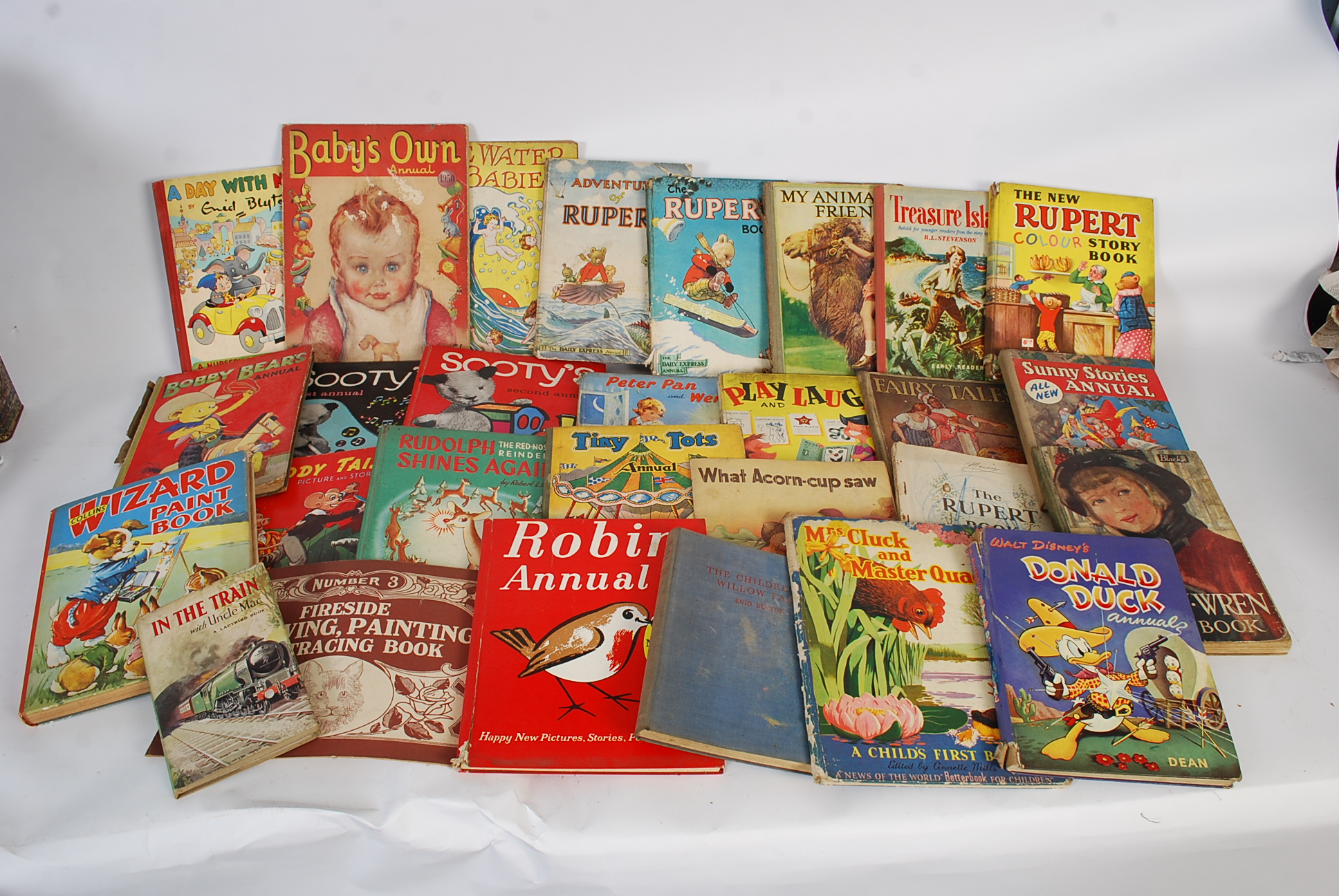 A collection of vintage annuals to include Rupert the Bear, Donald Duck, Treasure Island, Robin